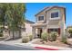 Inviting two-story home showcasing a cozy covered porch, well-kept landscaping, and a convenient attached two car garage at 5656 Fast Payout Ct, Las Vegas, NV 89122