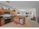 Open kitchen with stainless steel appliances, granite countertops, and a view of the dining and living spaces at 5656 Fast Payout Ct, Las Vegas, NV 89122