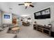 Comfortable living room with a large TV, open floor plan, and a view of the adjacent dining area and kitchen at 5656 Fast Payout Ct, Las Vegas, NV 89122