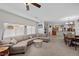 Bright living room featuring a comfortable sectional sofa and large windows overlooking the neighborhood at 5656 Fast Payout Ct, Las Vegas, NV 89122