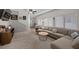 Bright living room with a cozy sectional sofa, modern furnishings, and plenty of natural light, perfect for gatherings at 5656 Fast Payout Ct, Las Vegas, NV 89122