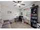 Functional office space featuring a ceiling fan, a large window, and ample storage with a bookshelf and drawers at 5656 Fast Payout Ct, Las Vegas, NV 89122