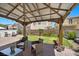 Charming covered patio featuring comfortable seating and a view of the serene backyard garden at 5656 Fast Payout Ct, Las Vegas, NV 89122
