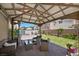 Relaxing covered patio with stylish wicker furniture and a well-maintained brick floor perfect for outdoor entertaining at 5656 Fast Payout Ct, Las Vegas, NV 89122