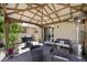 Inviting patio with a grill, dining seating, and lush greenery ideal for enjoying outdoor meals and relaxation at 5656 Fast Payout Ct, Las Vegas, NV 89122