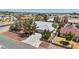 An elevated view showcasing the desert home's concrete driveway and landscaped front yard, surrounded by desert vegetation at 5981 Doubletree Rd, Pahrump, NV 89061