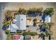 An aerial view of the property showcases the house, guest house, trees, landscaping, and surrounding desert terrain at 5981 Doubletree Rd, Pahrump, NV 89061