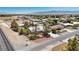 Aerial shot of a desert home with a tile roof, featuring mature trees and a fenced yard in a quiet neighborhood at 5981 Doubletree Rd, Pahrump, NV 89061