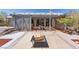 Landscaped backyard featuring a covered patio, fire pit, and privacy fencing at 5981 Doubletree Rd, Pahrump, NV 89061