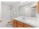 Well-lit bathroom with a shower-tub combo and ample counter space with storage at 5981 Doubletree Rd, Pahrump, NV 89061