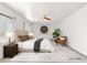 Comfortable bedroom with a ceiling fan, a large window, and a cozy seating area with a houseplant at 5981 Doubletree Rd, Pahrump, NV 89061