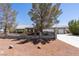 The exterior view showcases a single-story house with a two-car garage, desert landscaping, and a secure fence at 5981 Doubletree Rd, Pahrump, NV 89061