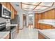 A view of the kitchen showcases stainless steel appliances, wood cabinets, and tile countertops at 5981 Doubletree Rd, Pahrump, NV 89061
