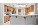 A kitchen showcases stainless steel appliances, wood cabinets, tile countertops, and a breakfast bar area at 5981 Doubletree Rd, Pahrump, NV 89061