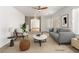 A modern living room features stylish furniture, neutral tones, a ceiling fan, and natural light from the windows at 5981 Doubletree Rd, Pahrump, NV 89061