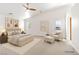 Spacious main bedroom featuring neutral tones, a ceiling fan, and a cozy seating area at 5981 Doubletree Rd, Pahrump, NV 89061