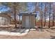 Small, detached outbuilding with a decorative pergola and a white door, surrounded by trees and a wooden fence at 5981 Doubletree Rd, Pahrump, NV 89061