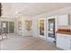 Covered patio with ceiling fan and multiple entry points to the interior, perfect for entertaining at 5981 Doubletree Rd, Pahrump, NV 89061