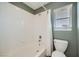 Bathroom with white tile, shower-tub combo, and window with blinds at 6125 Broken Slate Way, Las Vegas, NV 89139