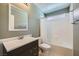 A well-lit bathroom with a shower, a vanity, and a toilet at 6125 Broken Slate Way, Las Vegas, NV 89139