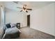 A clean, carpeted bedroom with a daybed, a ceiling fan, and a window with blinds at 6125 Broken Slate Way, Las Vegas, NV 89139