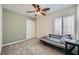 Neutral bedroom featuring a ceiling fan, a large window, and carpet at 6125 Broken Slate Way, Las Vegas, NV 89139