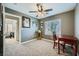 A cozy bedroom with a window, carpeted floors, and a ceiling fan at 6125 Broken Slate Way, Las Vegas, NV 89139