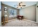 This bedroom has a window for natural light, carpeted floors, and a ceiling fan at 6125 Broken Slate Way, Las Vegas, NV 89139