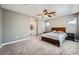 Bedroom with carpet, ceiling fan, and view of the en-suite bathroom at 6125 Broken Slate Way, Las Vegas, NV 89139