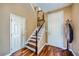 Welcoming entryway with wood floors, staircase, and coat closet, offering a warm and inviting feel at 6125 Broken Slate Way, Las Vegas, NV 89139