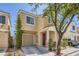 Inviting two-story home with a well-maintained lawn and a cozy front porch with stone accents at 6125 Broken Slate Way, Las Vegas, NV 89139