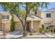 Charming two-story home featuring a well-maintained yard, covered porch, and attached garage at 6125 Broken Slate Way, Las Vegas, NV 89139