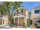Inviting exterior with a covered porch and mature trees, creating an attractive curb appeal at 6125 Broken Slate Way, Las Vegas, NV 89139