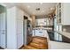 Well-lit kitchen with stainless steel appliances, white cabinets, hardwood floors, and granite countertops at 6125 Broken Slate Way, Las Vegas, NV 89139