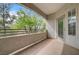 Enjoy the outdoors from this balcony with views of green trees, framed by railings and textured stucco at 6160 Rumrill St # 202, Las Vegas, NV 89113