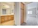 Bathroom with wood flooring, oak cabinets, sink, and large mirror at 6160 Rumrill St # 202, Las Vegas, NV 89113