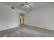 Carpeted bedroom featuring a ceiling fan and arched doorway at 6160 Rumrill St # 202, Las Vegas, NV 89113