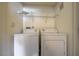 Efficient laundry area featuring a stacked washer and dryer with convenient overhead shelving for storage at 6160 Rumrill St # 202, Las Vegas, NV 89113