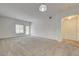 Spacious carpeted living room featuring neutral walls, large windows, and access to the entry hall at 6160 Rumrill St # 202, Las Vegas, NV 89113