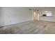 Living room features neutral walls, carpet, and arched entry to kitchen at 6160 Rumrill St # 202, Las Vegas, NV 89113