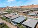 A high angle view of homes and community landscaping featuring mature trees and desert scenery at 64 Lake Oasis St, Henderson, NV 89011