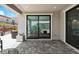 Covered back patio with pavers and view through sliding glass doors to the dining area at 64 Lake Oasis St, Henderson, NV 89011
