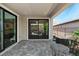 Covered back patio with view through sliding glass doors to the kitchen at 64 Lake Oasis St, Henderson, NV 89011
