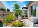 Serene backyard with a water feature, lush landscaping, and wrought iron fence at 64 Lake Oasis St, Henderson, NV 89011