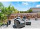 Outdoor patio seating area with modern fire pit and rock wall at 64 Lake Oasis St, Henderson, NV 89011