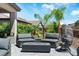 Outdoor patio seating area with modern fire pit and privacy landscaping at 64 Lake Oasis St, Henderson, NV 89011