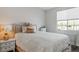 Cozy bedroom with a tufted headboard and soft lighting from the bedside lamp at 64 Lake Oasis St, Henderson, NV 89011