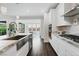 Bright kitchen with white cabinets, stainless appliances, and granite counters at 64 Lake Oasis St, Henderson, NV 89011