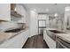 Bright kitchen with white cabinets, stainless appliances, and granite counters at 64 Lake Oasis St, Henderson, NV 89011
