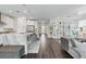 Bright, open-concept living area featuring modern decor, hardwood floors, and a stylish kitchen island at 64 Lake Oasis St, Henderson, NV 89011